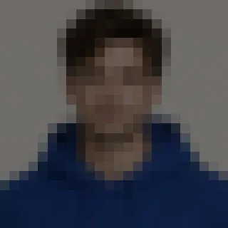 A heavily pixelated, low-resolution head-and-shoulders photo