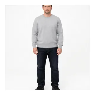 Man in a grey sweater and dark jeans standing, photographed from head to shoes on white