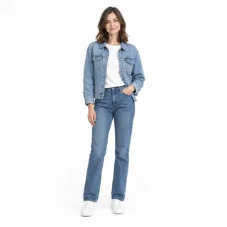 A woman in a denim jacket and jeans standing, head to shoes, on a white background
