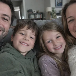 A close family selfie where the frame cuts through heads and the people at both sides