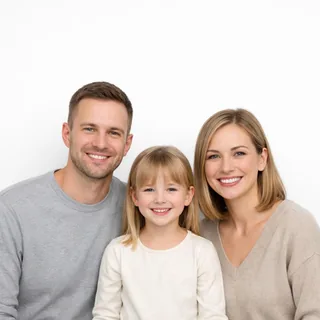 A family of three on a white background, framed from the waist up with space above their heads