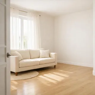 Bright, tidy living room with a cream sofa and an empty corner by the window