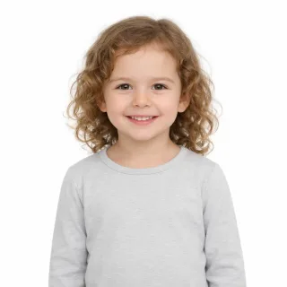 Smiling young girl on her own on white, framed from the waist up