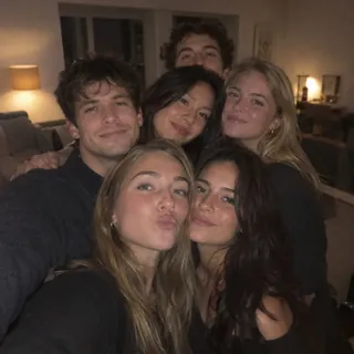 Six friends squeezed into a selfie at a party, faces overlapping and partly hidden