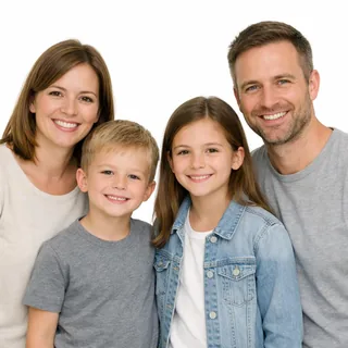 A mother, a father and two kids smiling at the camera against a white background