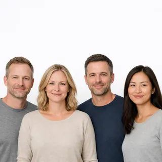 Four adults side by side against white, every head fully in frame