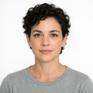 A woman facing the camera against a white background