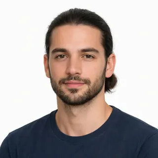 A man with his hair tied back, forehead and ears clear