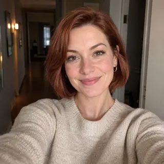 A selfie with an open doorway softly blurred behind the woman