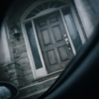 A tilted close-up of a front door taken from a car
