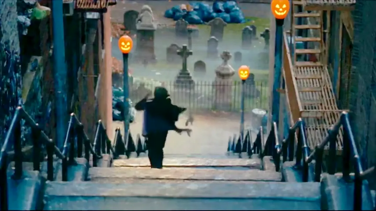 A dancer in a high-collared black cape spinning on a foggy stone staircase at night