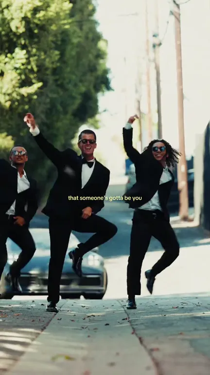 The dancers mid-hop, each with a knee lifted and one fist raised
