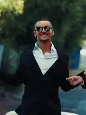 The left dancer in the example, smiling in sunglasses, a black suit and an open white collar