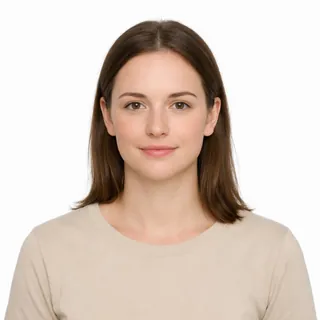 A woman photographed chest up, facing the camera on a white background