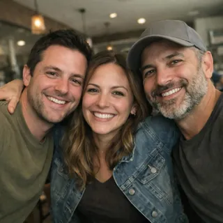 Three friends hugging in a café snapshot