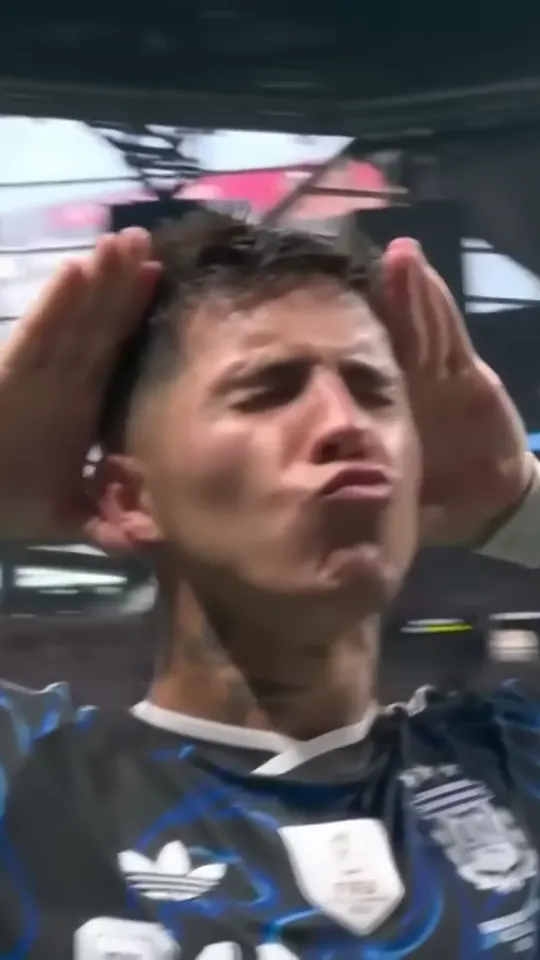 The scorer faces the camera with both hands cupped behind the ears and a pout