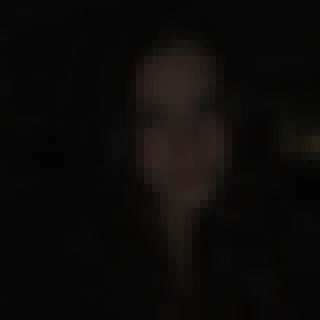 A dark, blurry, pixelated portrait that is hard to recognize