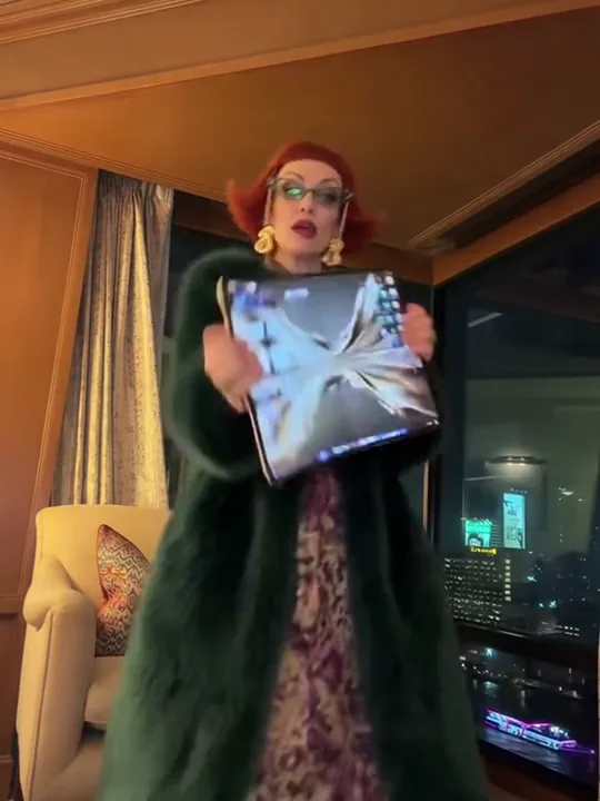 A person standing head to shoes in a bright room, ready for the phone dance