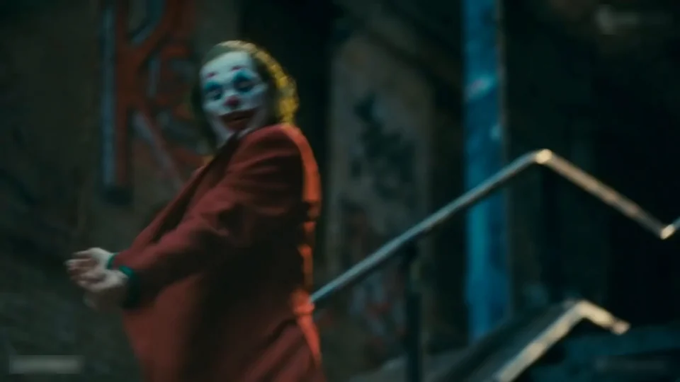 The dancer spinning on the steps, seen from the side, the jacket swinging out