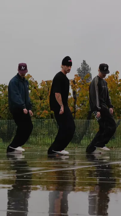 Each dancer steps one foot forward and leans back.