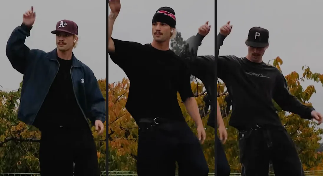 The left, center and right dancers cut from one frame: the same blond man with a moustache in a maroon cap and denim jacket, a black beanie and black T-shirt, and a black cap and dark long-sleeve top.