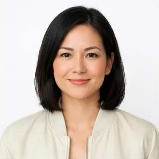 A woman with a black bob facing the camera, mouth and jaw clearly visible, on a white background
