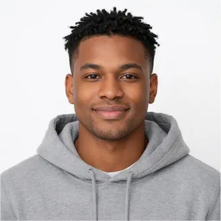 A young man in a grey hoodie photographed chest up against a plain white background