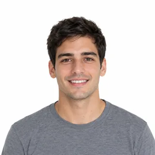 Head-and-shoulders photo of a smiling young man in a grey tee on a white background