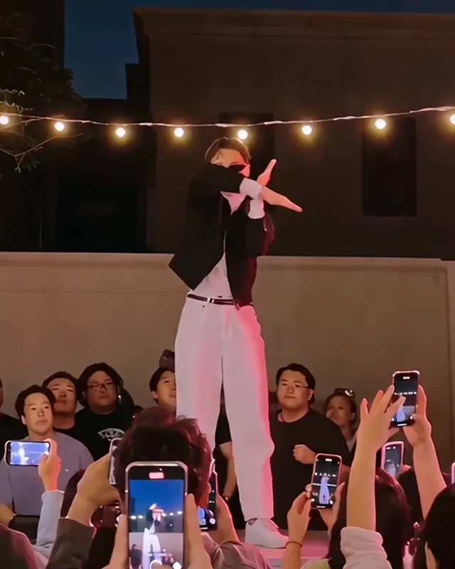 The dancer crossing both forearms in an X in front of the face
