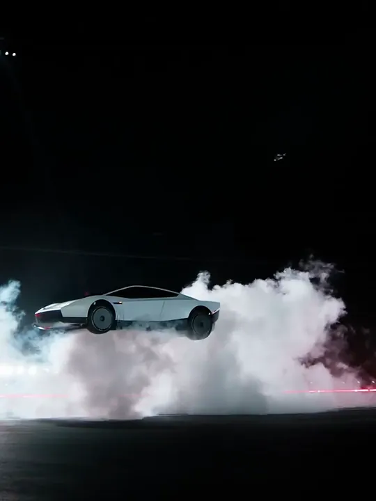 A car dropping onto the ground in billowing white smoke at night