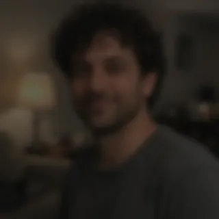 Dim, blurry snapshot of a man in a living room