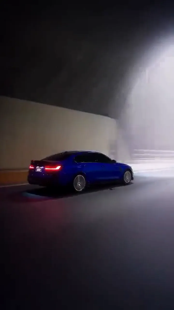 The full-size car driving on a night road with its headlights on