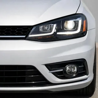 A car cropped so tightly that only the front bumper and one headlight are in frame