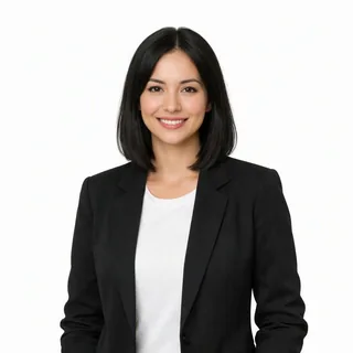 Waist-up photo of a smiling woman in a black blazer on a white background