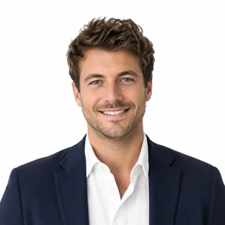 Head-and-shoulders photo of a smiling man in a navy blazer on a white background