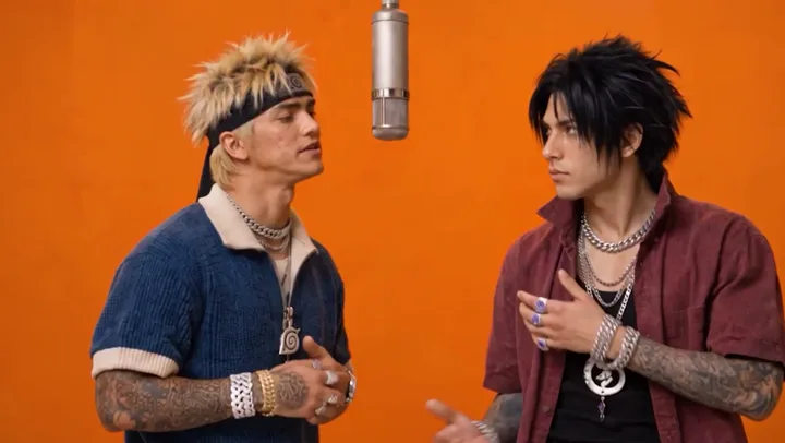 A blonde and dark-haired duo in a Hotel Lobby inspired performance scene.